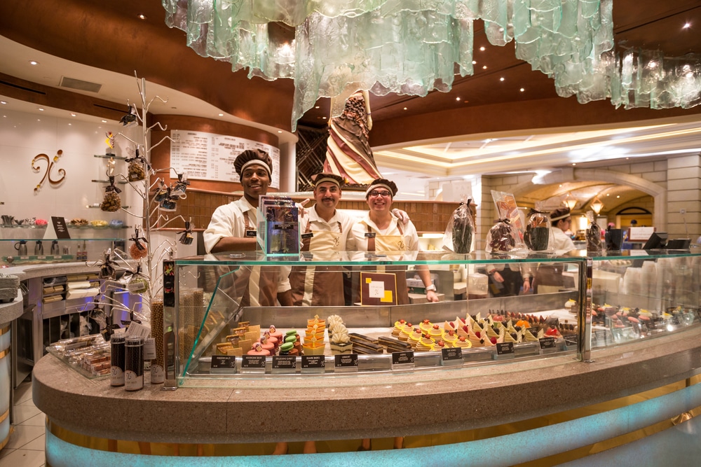 Image of three bakery workers behind the counter at the Bellagio, one of the best bakeries on the Strip
