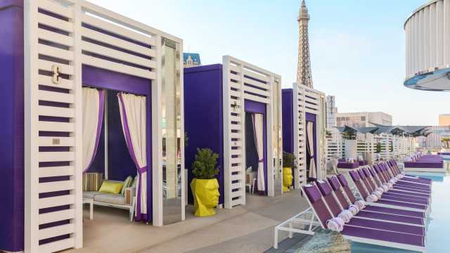 Image of purple pool cabanas and lounge chairs at The Cosmopolitan