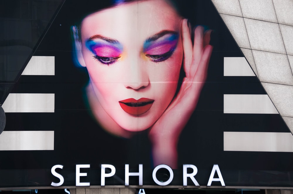 Image of a woman with pink and blue eyeshadow on a Sephora billboard