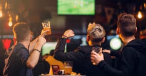 Image of three men watching a game at a sports bar