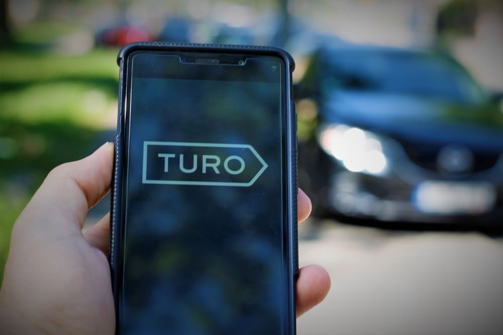 Image of a cell phone with the Turo logo on the screen