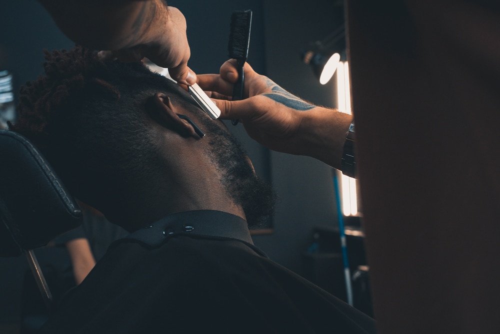 man getting a fresh shave and cut at barbershop 