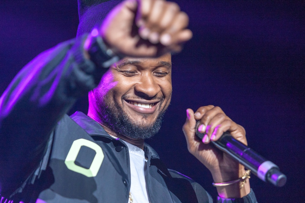 Singer and Songwriter Usher smiling during live performance 