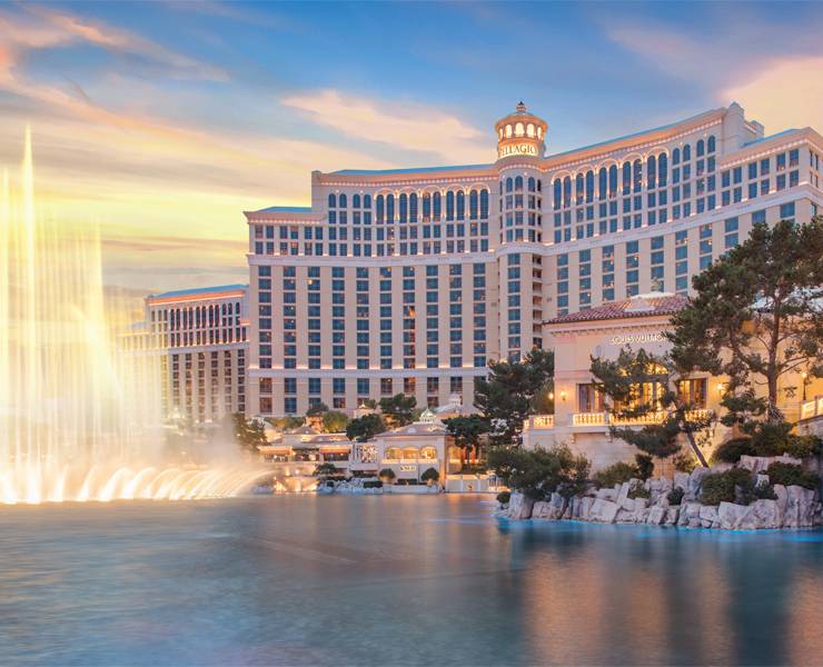 The Fountains at Bellagio during golden hour amongst the blue skies and clouds attractions on the Strip