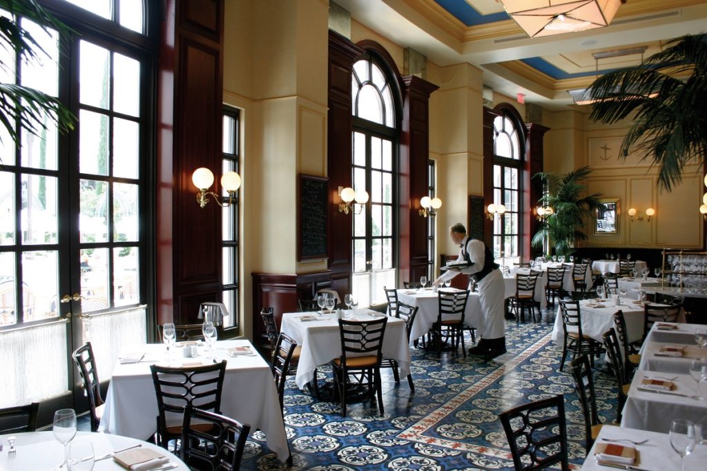Bouchon at The Venetian interior dining and seating area with waiter setting tables 