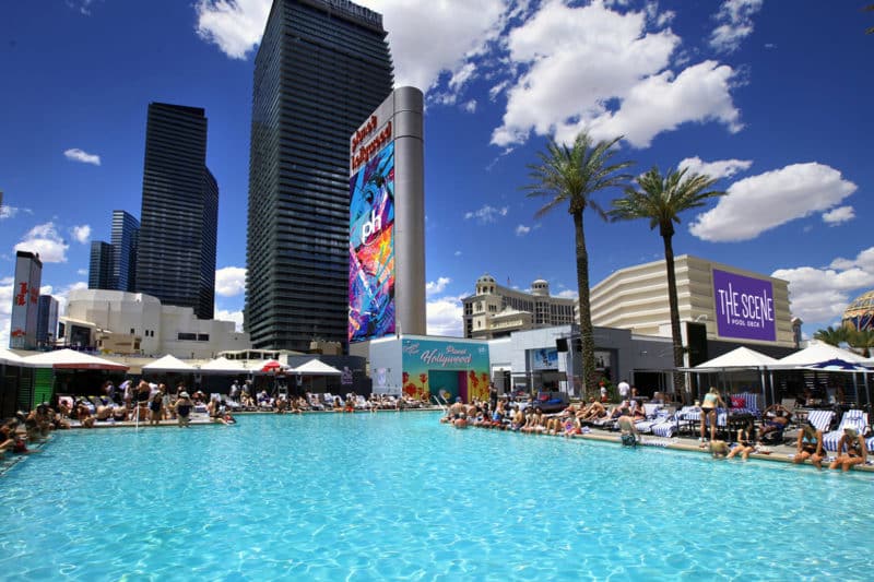 Planet Hollywood's 'The Scene Pool Deck' with clear blue water and loungers, Las Vegas.