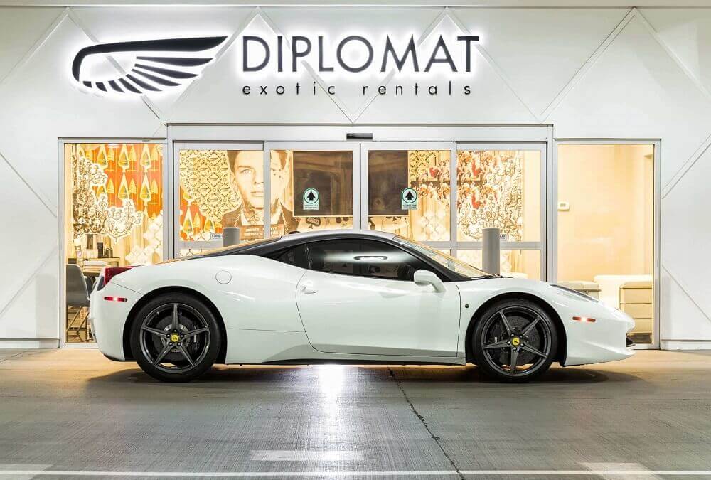 diplomat exotic rentals front entrance with exotic car parked before the doors