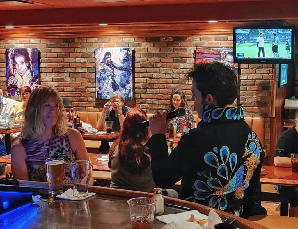 "Elvis" singing to Ellis Island customers at the bar  