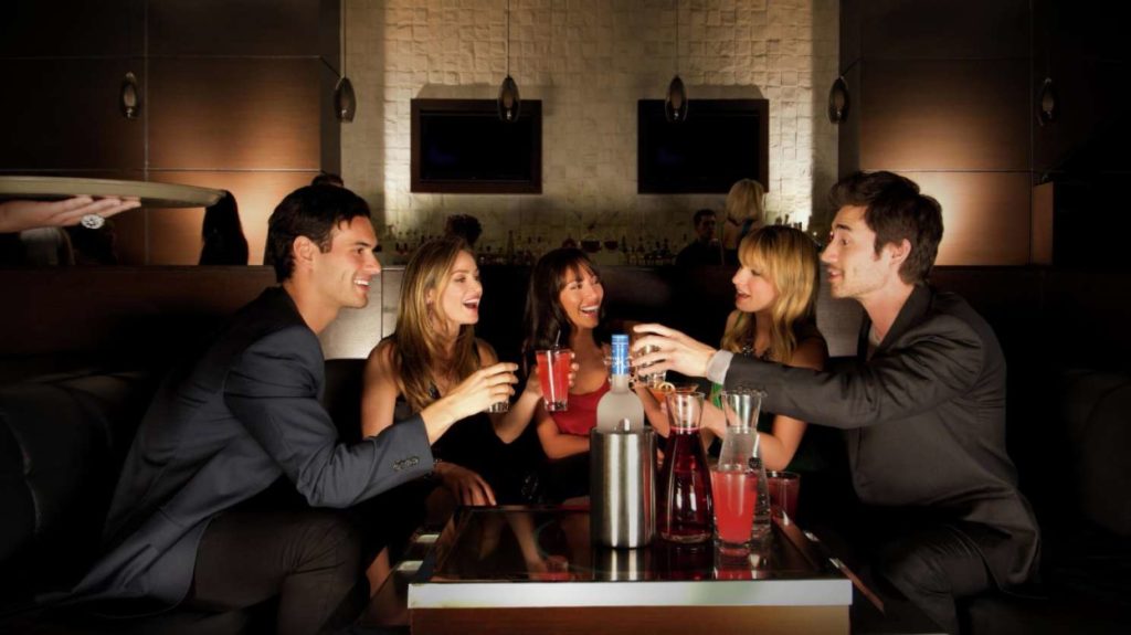 Las Vegas party goers enjoying cocktails at a table in Mandalay Bay 
