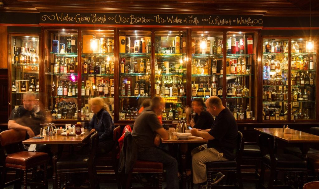 Ra Ra Irish Pub customers dining alongside alcohol display  