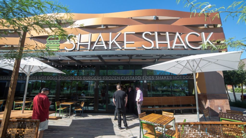 Shake Shack las vegas exterior sign and customers standing in line for burgers and fries 