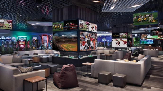 Caesars Sportsbook at the Linq interior seating area and sports playing on TV 