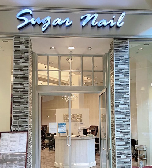 Sugar Nail front entry way sign and doors as one of the nail salons on the Strip