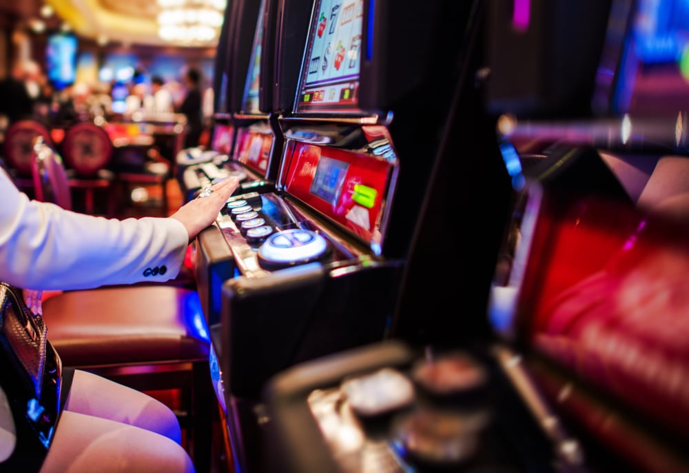 Image of a person playing slot machines