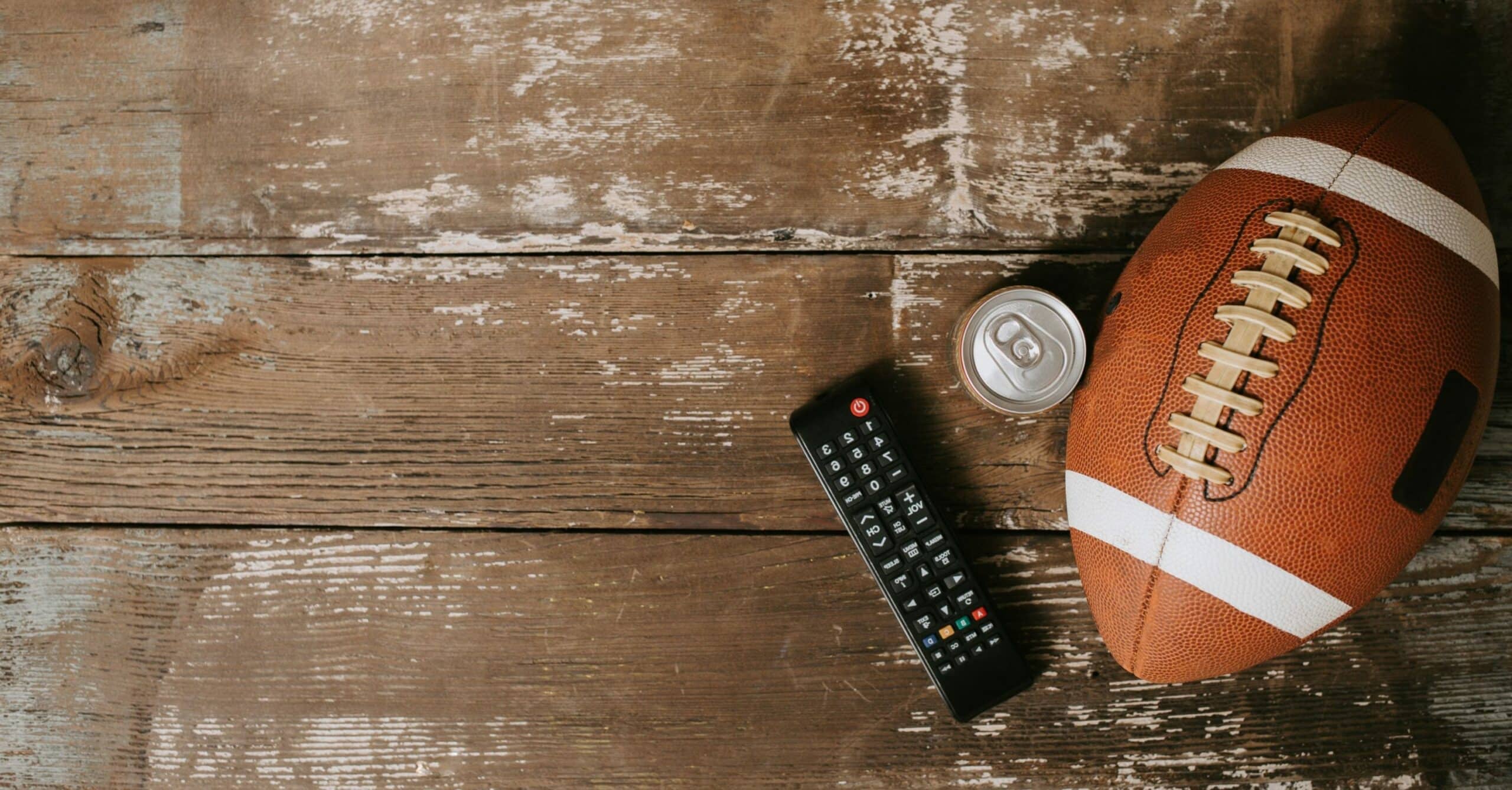 Football with a remote to watch big game parties in Las Vegas