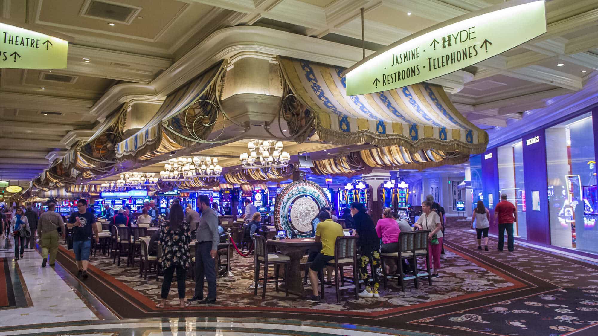 View of the Bellagio Casino floor in Las Vegas with lavish decor and gaming tables