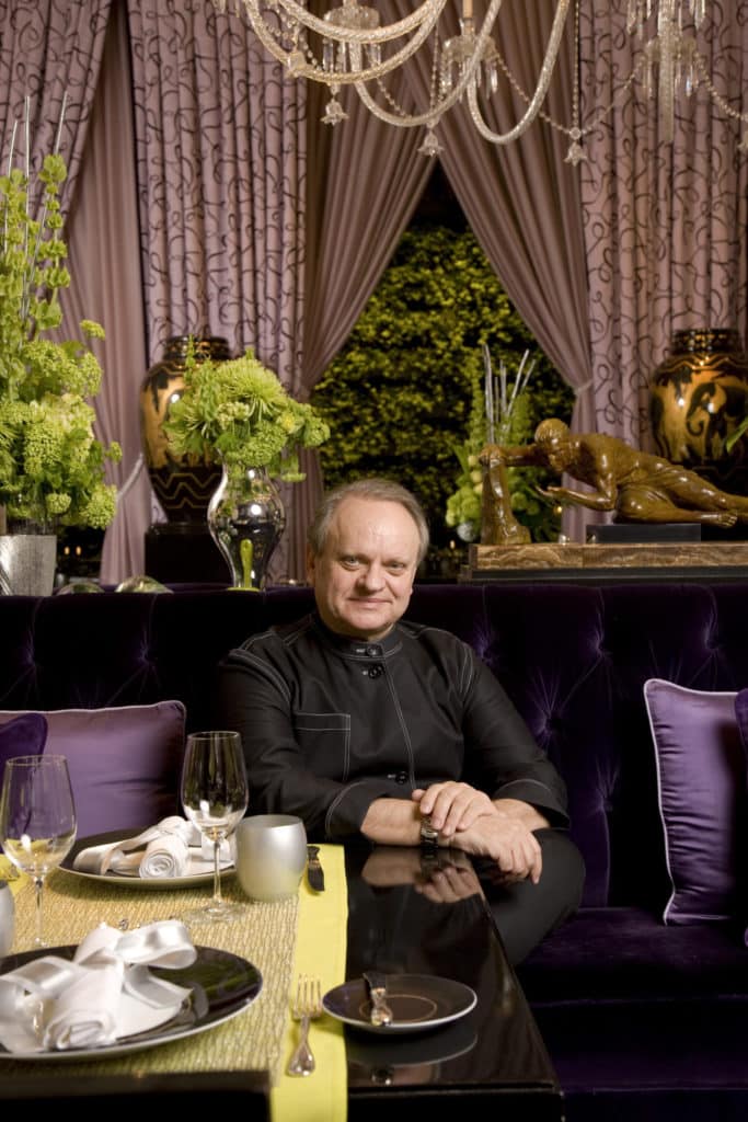 Chef Joël Robuchon sitting in a booth