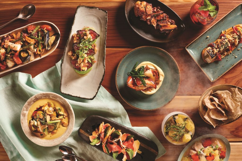 a table full of tapas on rustic plates