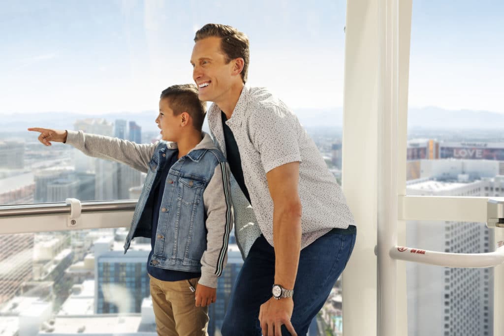 a father and son looking out of a High Roller pod
