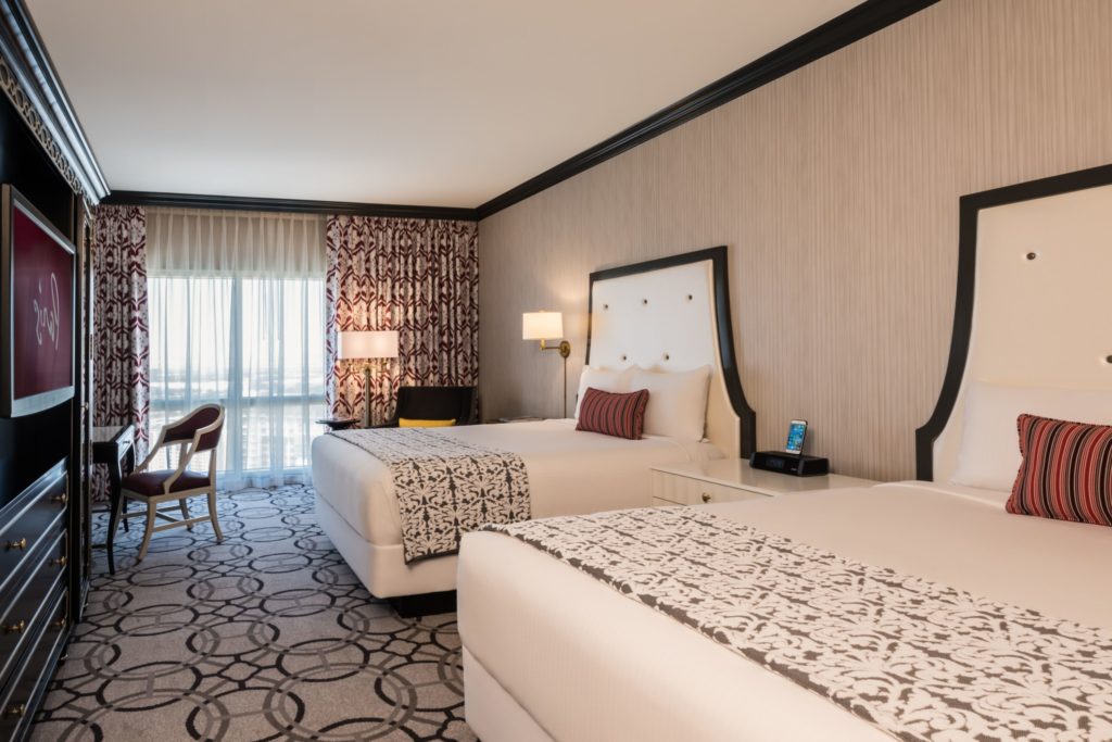 Elegant Burgundy Room with two plush beds at Paris Las Vegas Hotel.