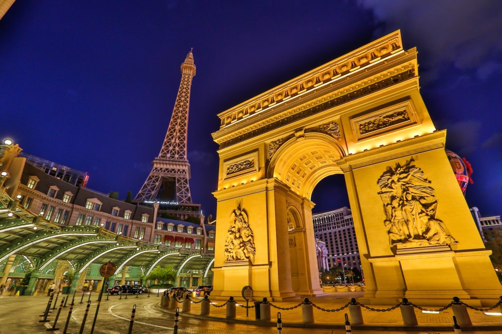 Night view of the iconic Paris Tower and Arc de Triomphe replica at Paris Las Vegas Hotel and Casino
