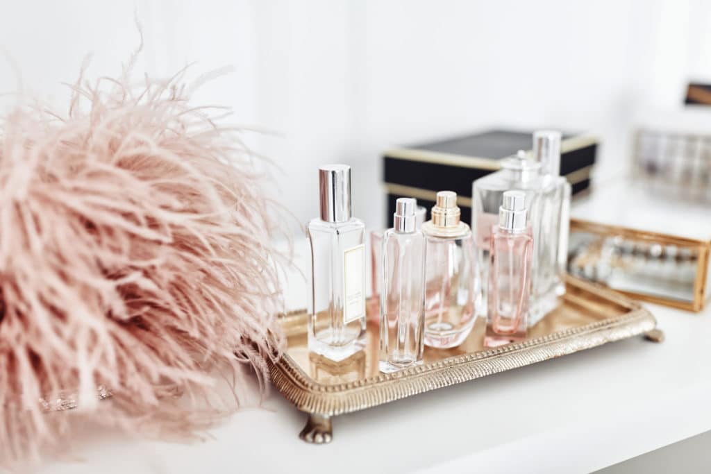 perfume bottles with pink feathers