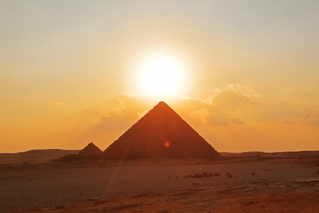 A pyramid with a setting sun