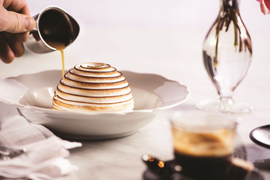 baked Alaska with sauce being poured on it at Bardot Brasserie