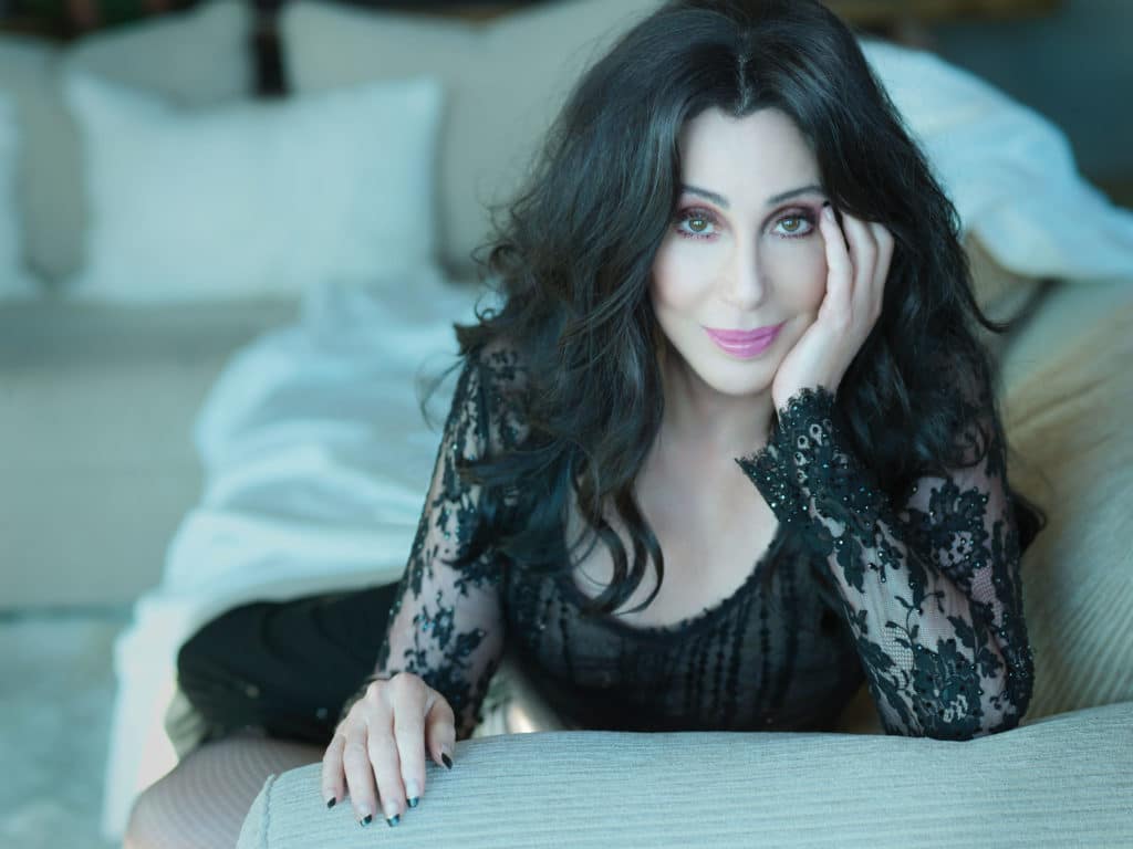 Cher on a white couch