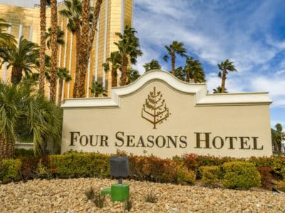 Daytime view of the Four Seasons Hotel entrance sign with the Mandalay Bay in the background