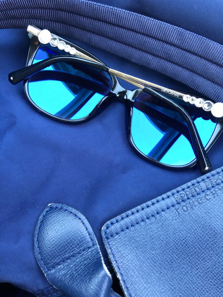 blue glasses with rhinestone exteriors on a blue bag