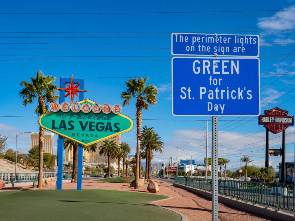 the Welcome to Las Vegas sign in green, welcoming visitors to the St. Patrick's Day events on the Strip