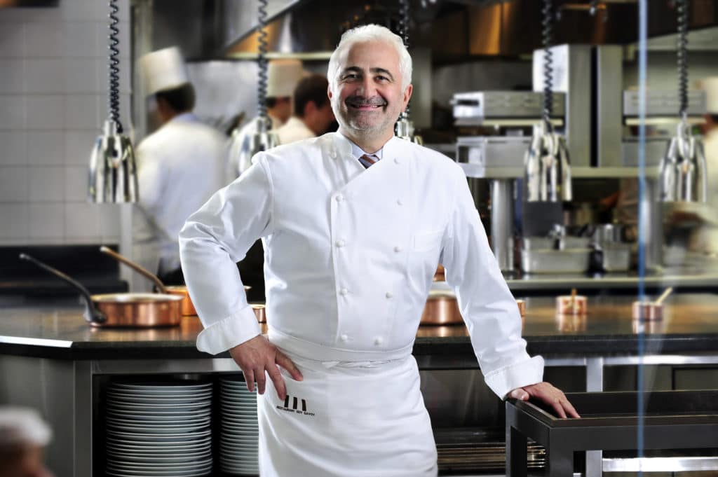 Guy Savoy smiling in chef clothes