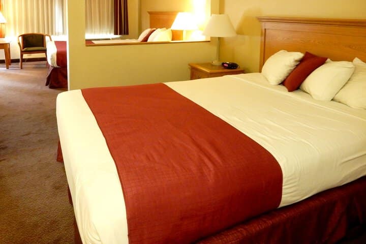 bed at Mardi Gras with red cover