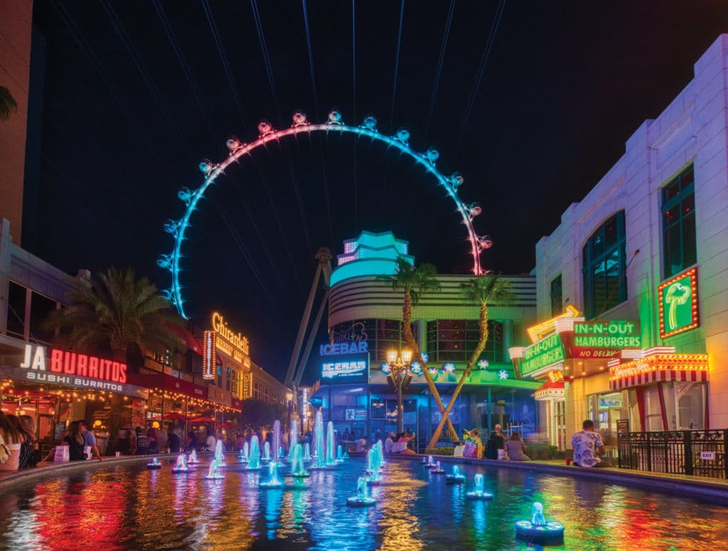 neon colored LINQ promenade and high roller at night