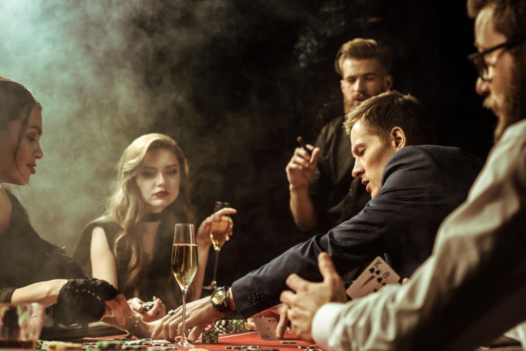 people playing poker with smoke and champagne