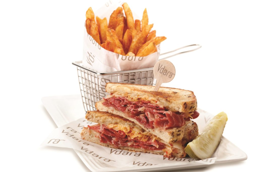 reuben sandwich with a basket of fries