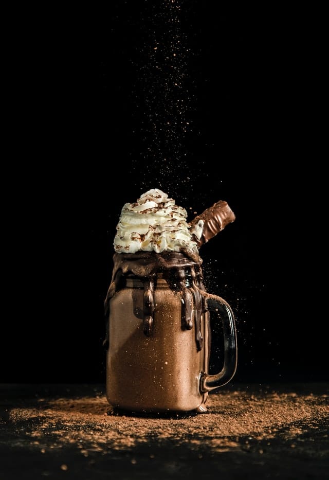 A Chocolate milkshake against a dark background