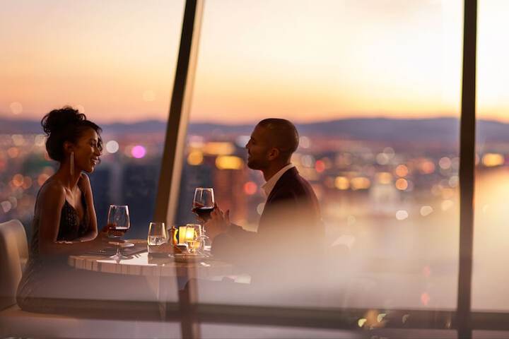 Couple enjoying a glass of wine from the top of the world