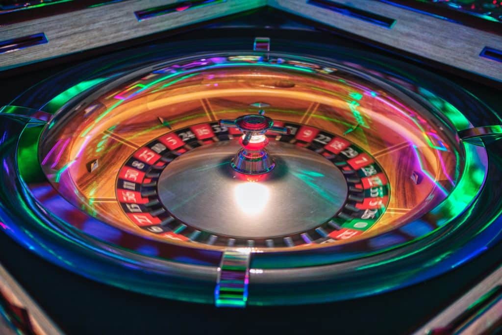 A neon roulette wheel spinning fast at New York New York