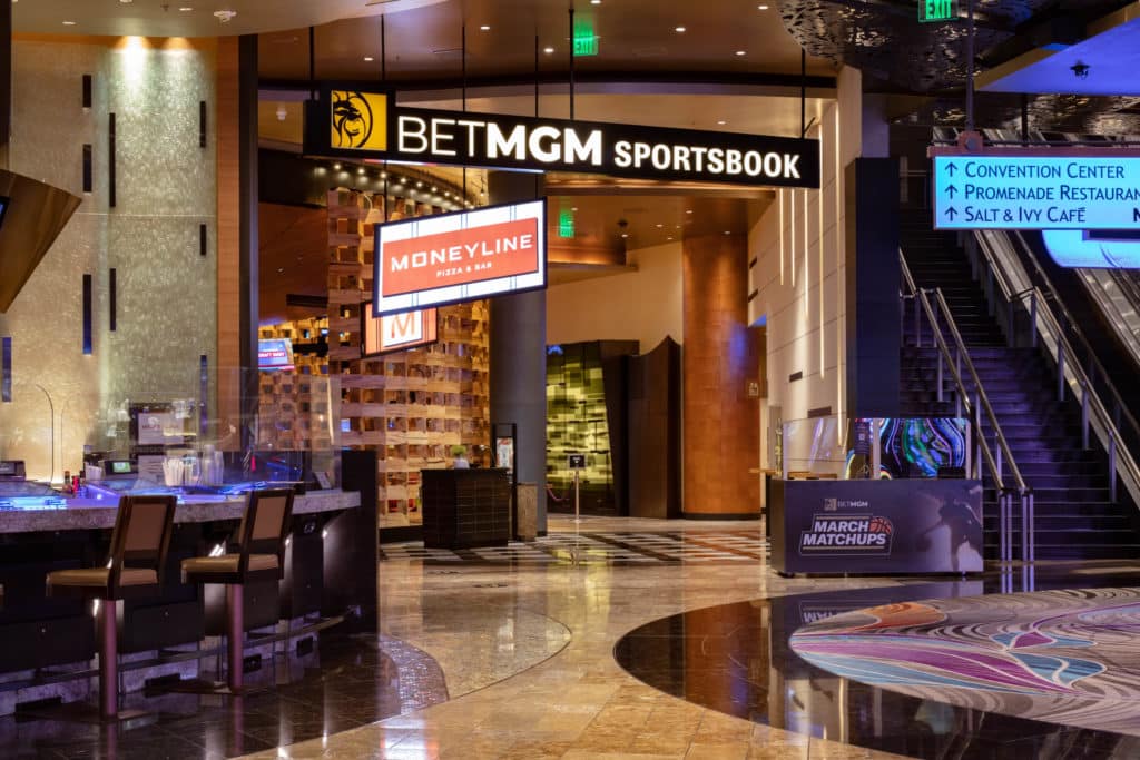 the entrance to the BetMGM Sportsbook and Moneyline pizza at ARIA