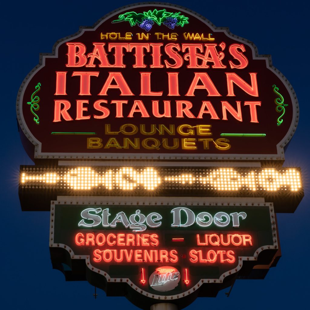 Battista's Hole in the Wall sign at dusk