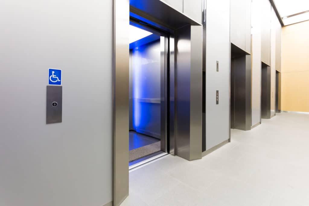 silver elevator doors with a handicap placard over the buttons