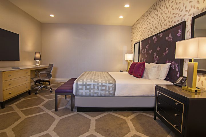 single bedroom with purple details and a red pillow