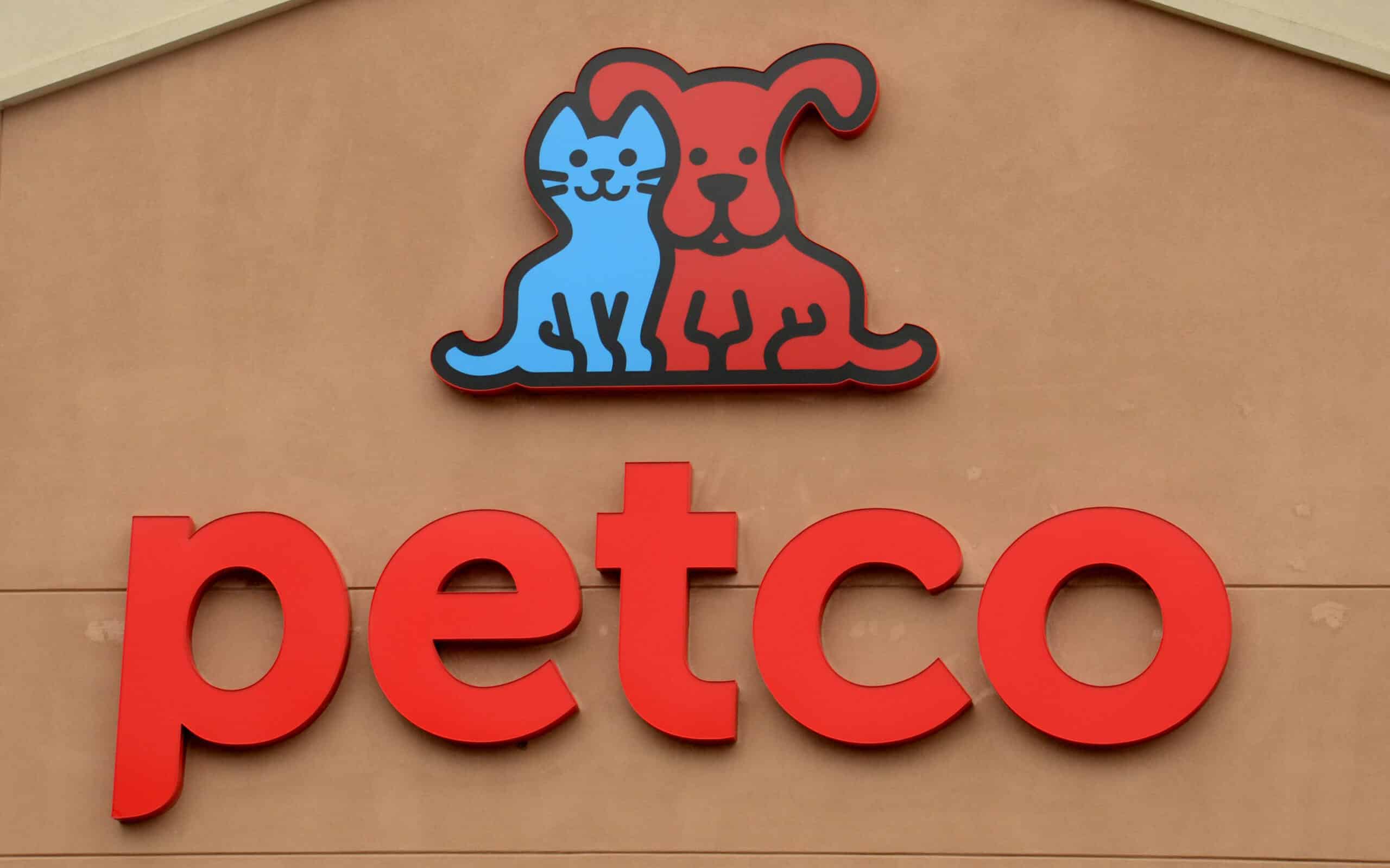 a PetCo sign outside on a tan building 