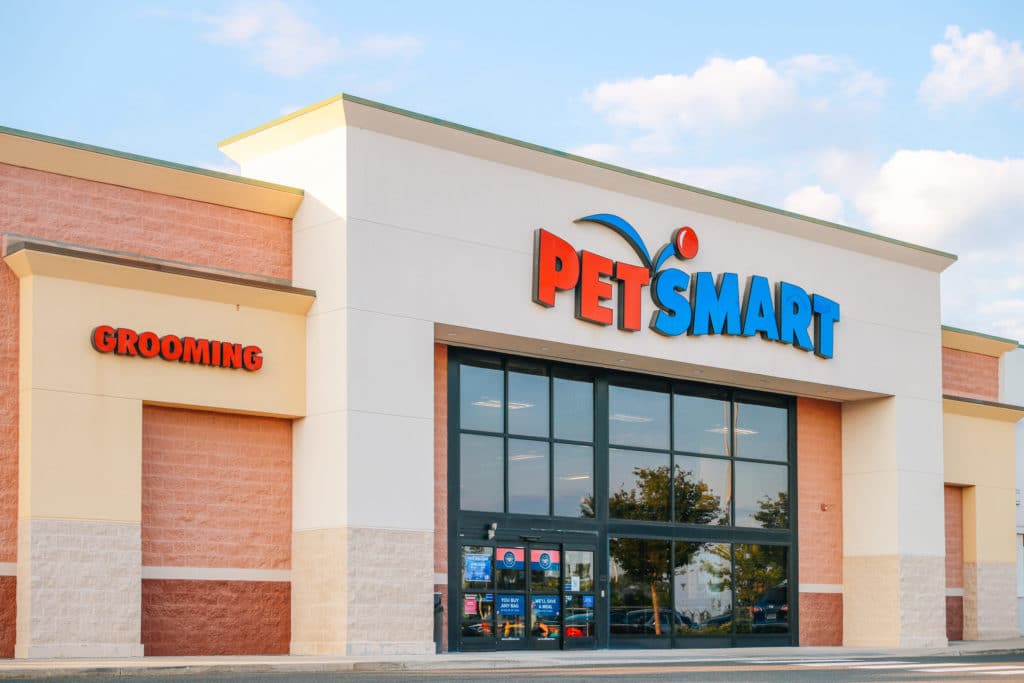 the exterior of a Petsmart during the day with white clouds in a blue sky