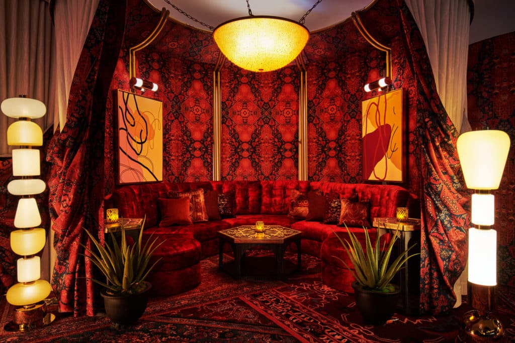 a dark, red velvet interior at The Shag Room at Virgin Hotels