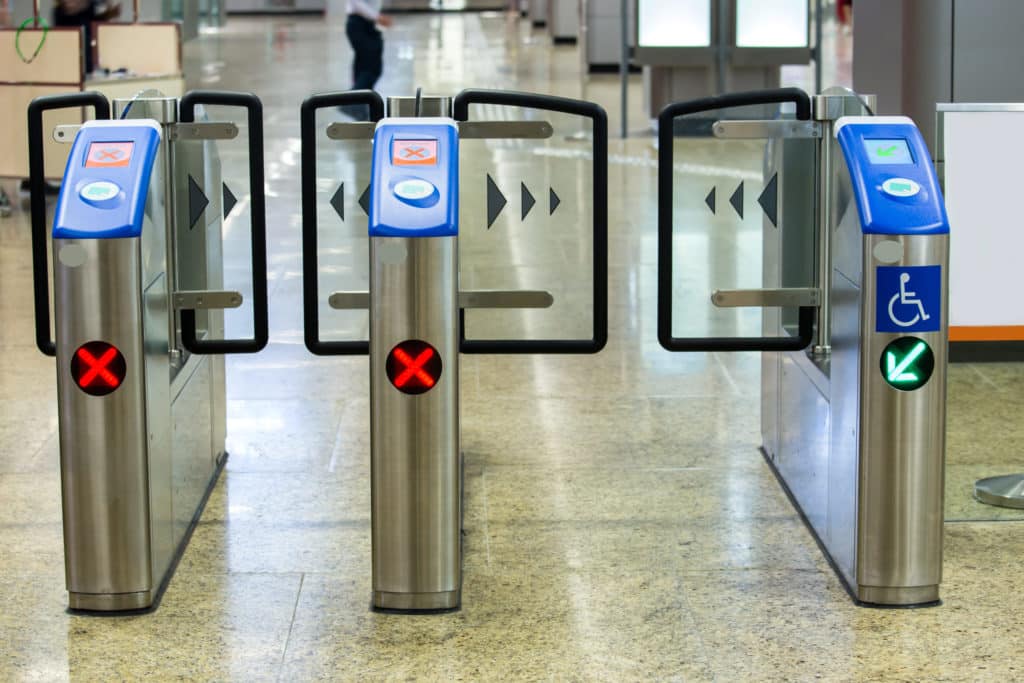 ticket scan doors at an airport with a handicap space