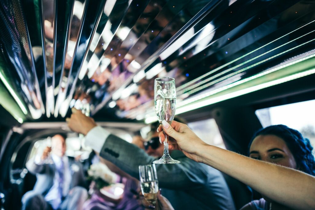 People enjoying Champagne in a limousine