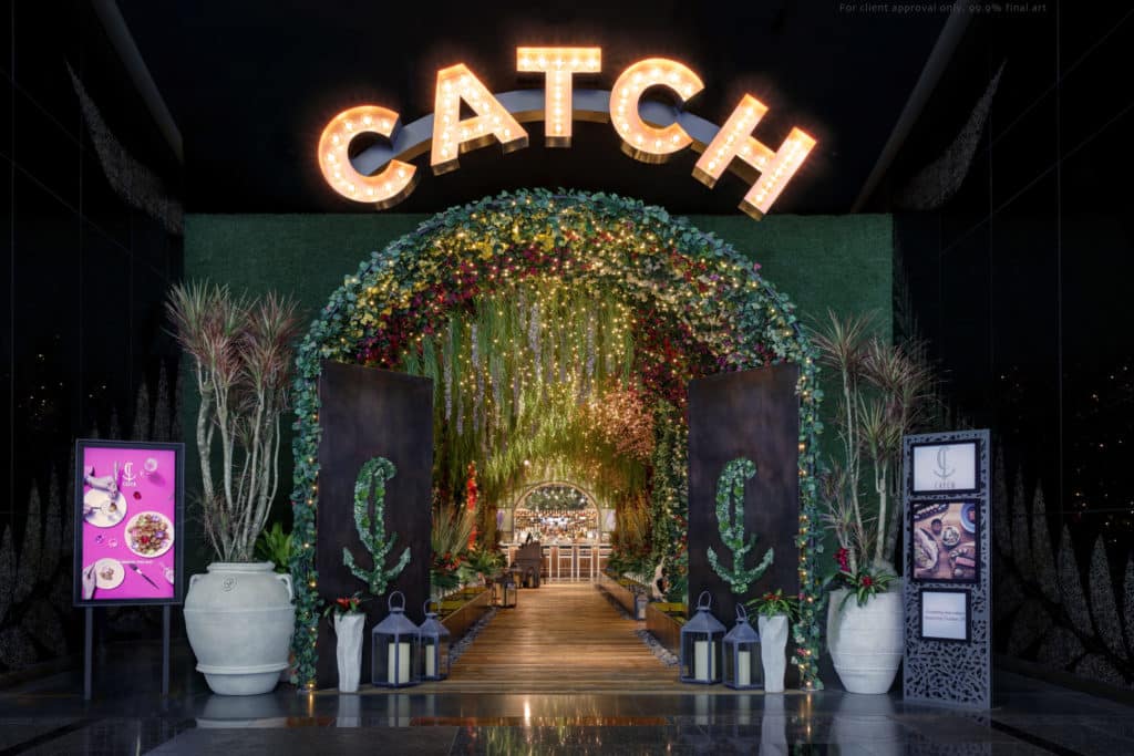 the entrance to CATCH at ARIA with plants and bright lights